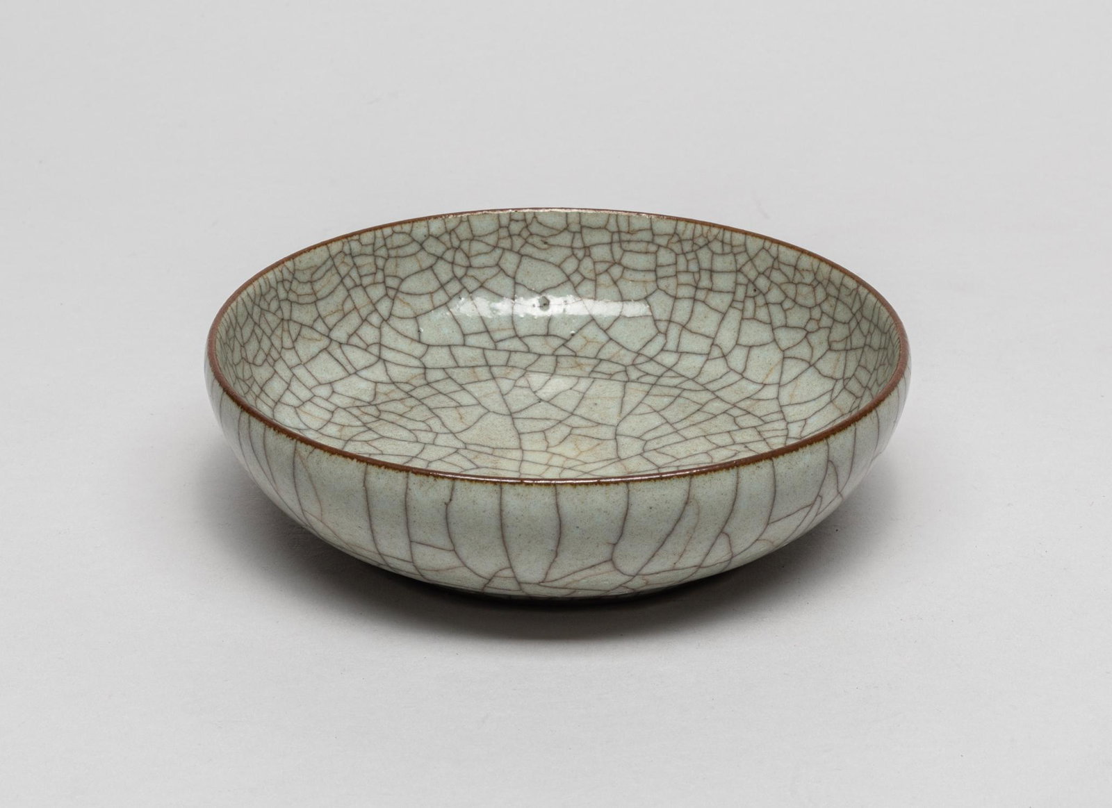 Rare Chinese Ge Ware Porcelain Washer: The shallow sides covered with a lustrous gray glaze suffused with a matrix of black and brown crackles save for the footring. 6.1inch W, 1.7inch H.
