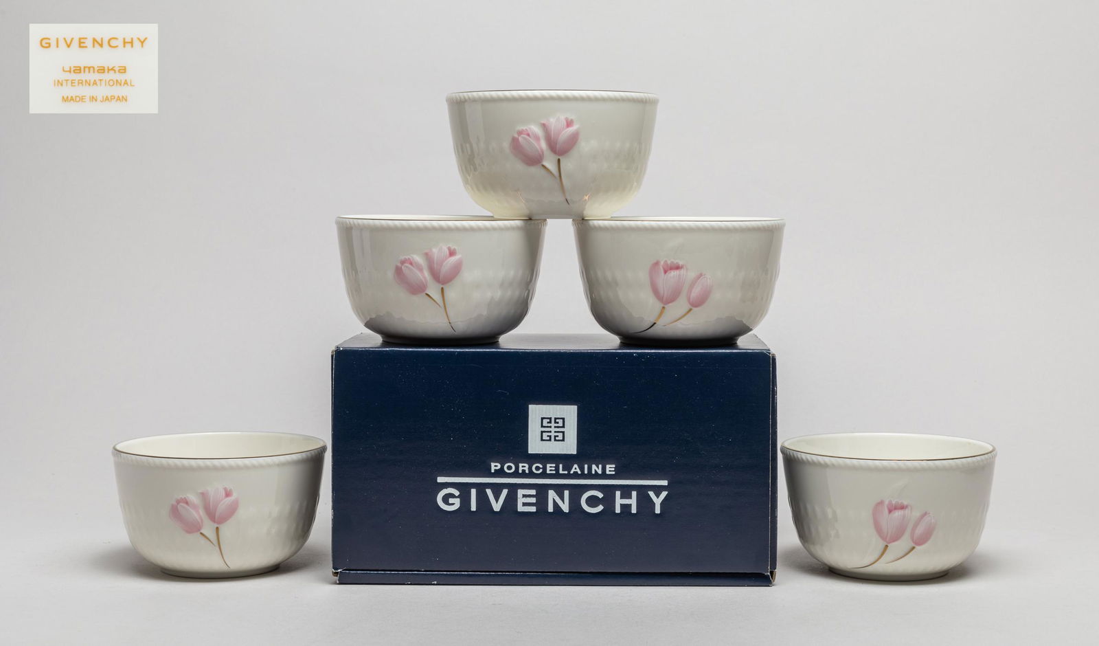 Set Givenchy Porcelain Bowls: Set of five porcelain bowls decorated with pink blossoms, the bottom marked Givenchy Yamaka International Made in Japan. 2.5inch H, 4.3inch W (each).