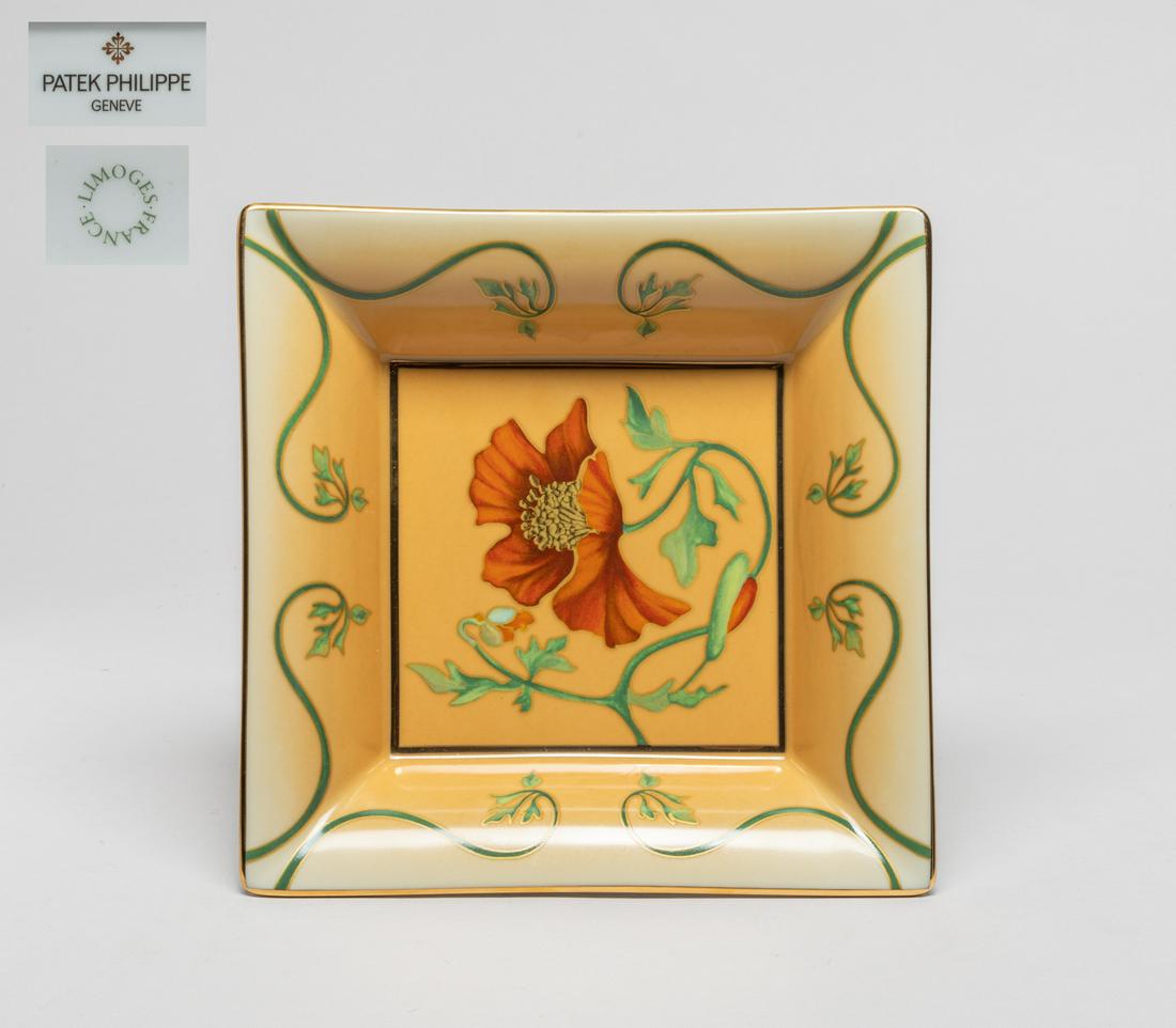 Patek Philippe Porcelain Plate/Tray: Of square section, the inside decorated with a red blossom borne on a curling leafy stem on a light brown ground, the base marked Patek Philippe Geneve France Limoges Collection 2013. 7.2inch L, 7.2in