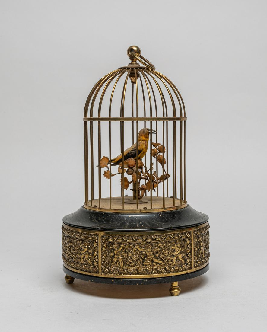 Antique Bird Cage Music Box: Special antique mastic box designed in bird cage form, the base carved with boys holding foliate scrolls. 9inch H, 5.6inch W.