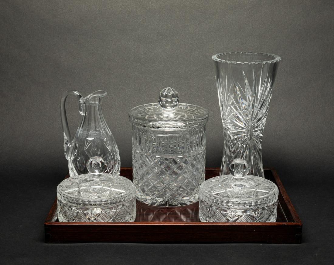 Continent Cut Crystal Glass Pieces: Including three covered candy jars, a vase and a pitcher, each finely cut with classical motif, with a wood tray. 11.8inch H, 5.5inch W.