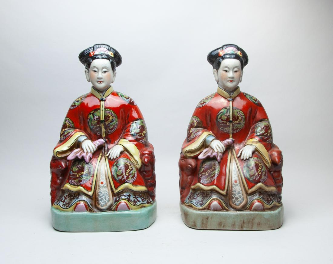 Collectible Chinese Famille Rose Porcelain Figures: The hollow figures seated on red-glazed chairs, wearing loose-fitting robes decorated with circular medallions of phoenix amidst clouds on a red ground, the face with meditative expression. 15.3inch H