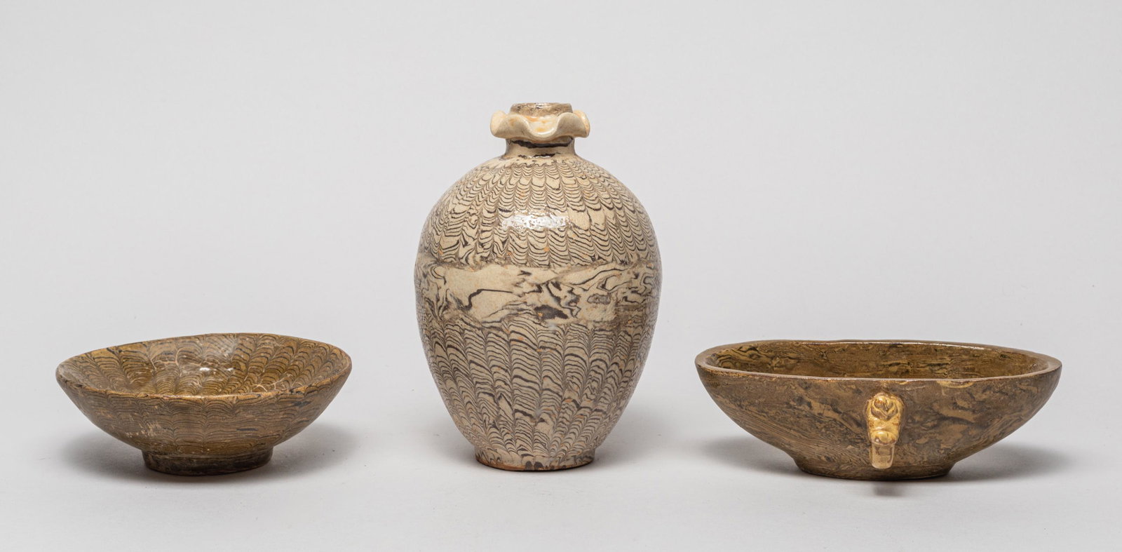 Set Chinese Woodlike Porcelains: Including a vase, a bowl and a washer, glazed with wood like pattern on a creamy or olive-green ground. 6.1inch H, 4.1inch W (largest).