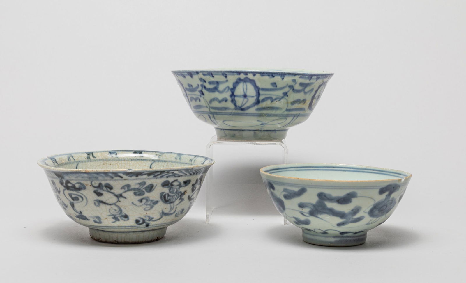 Antique Chinese Ming Porcelain Bowls: Including three blue and white porcelain bowls painted the inside and out with flower foliage, and a celadon glazed bowl. 6.3inch W, 2.3inch H (largest).