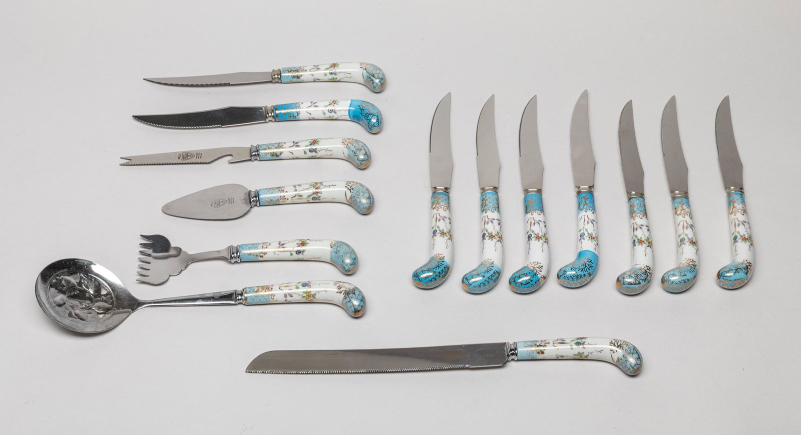 Blue Porcelain Handled Sheffield England Wares: Including 12 knives, a service fork and a service spoon, the porcelain handles painted with flowers. 10inch L, 2.5inch W (largest).