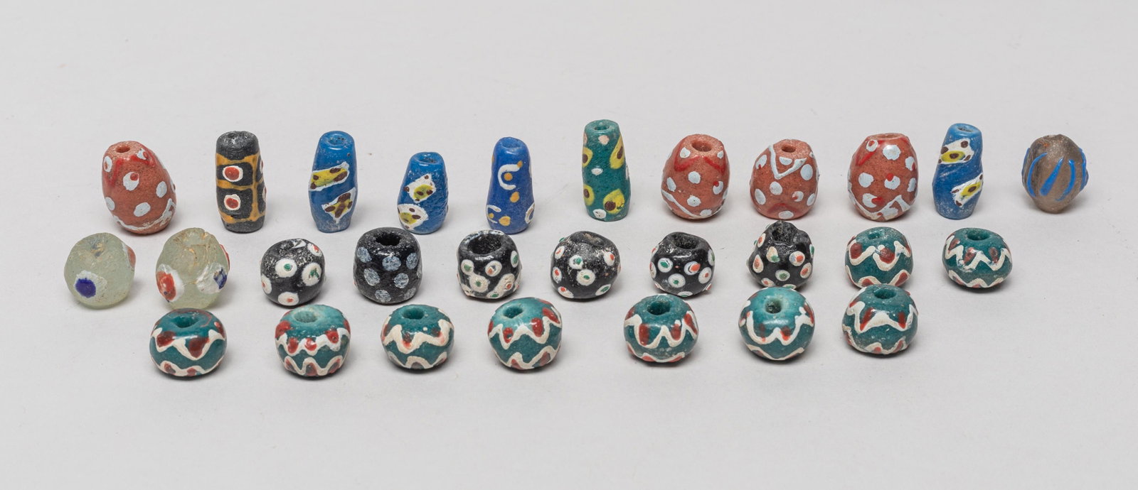 Antique African Krobo Glass Beads: A large group of African Krobo powder glass beads, about 28 pieces in total. 0.7inch L, 0.52inch W (largest).