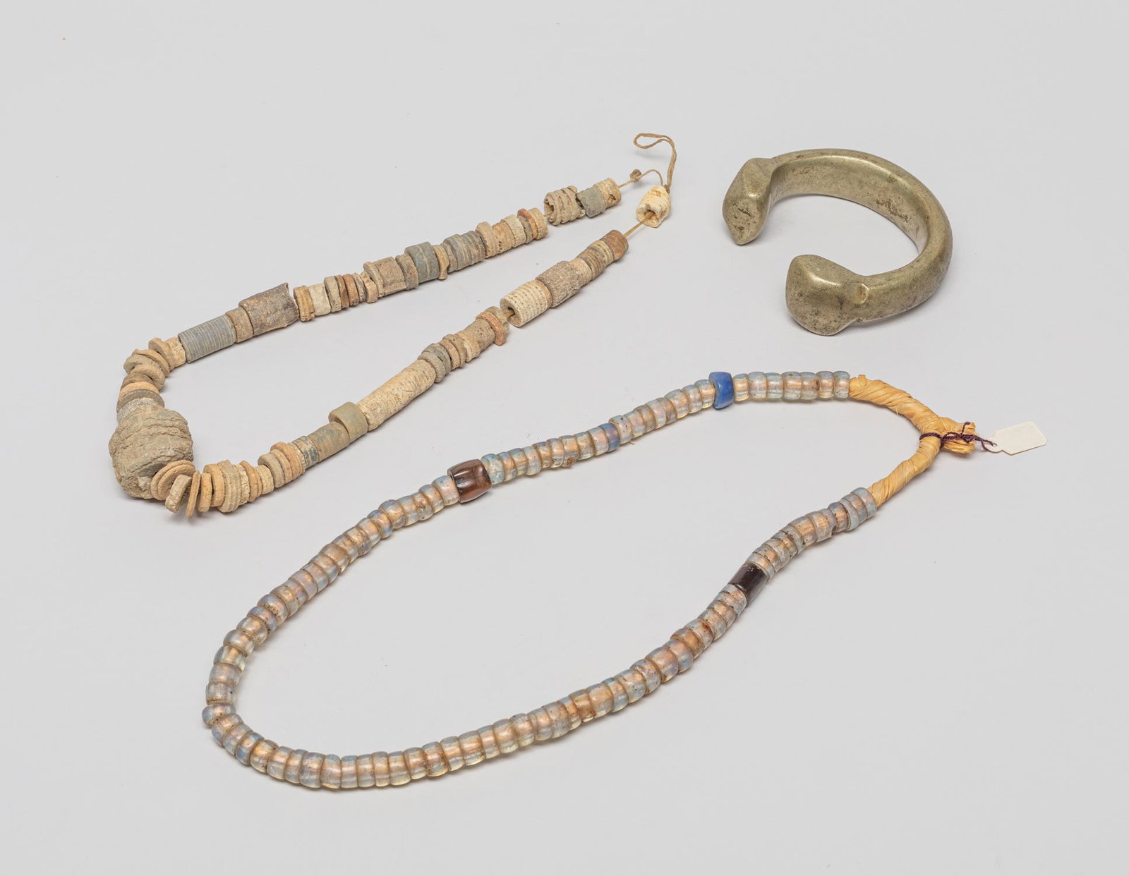 Antique African Agate, Fossil & Bronze Jewelry: Including a large bronze bangle, an agate necklace and a fossil necklace. 24inch L (largest necklace).