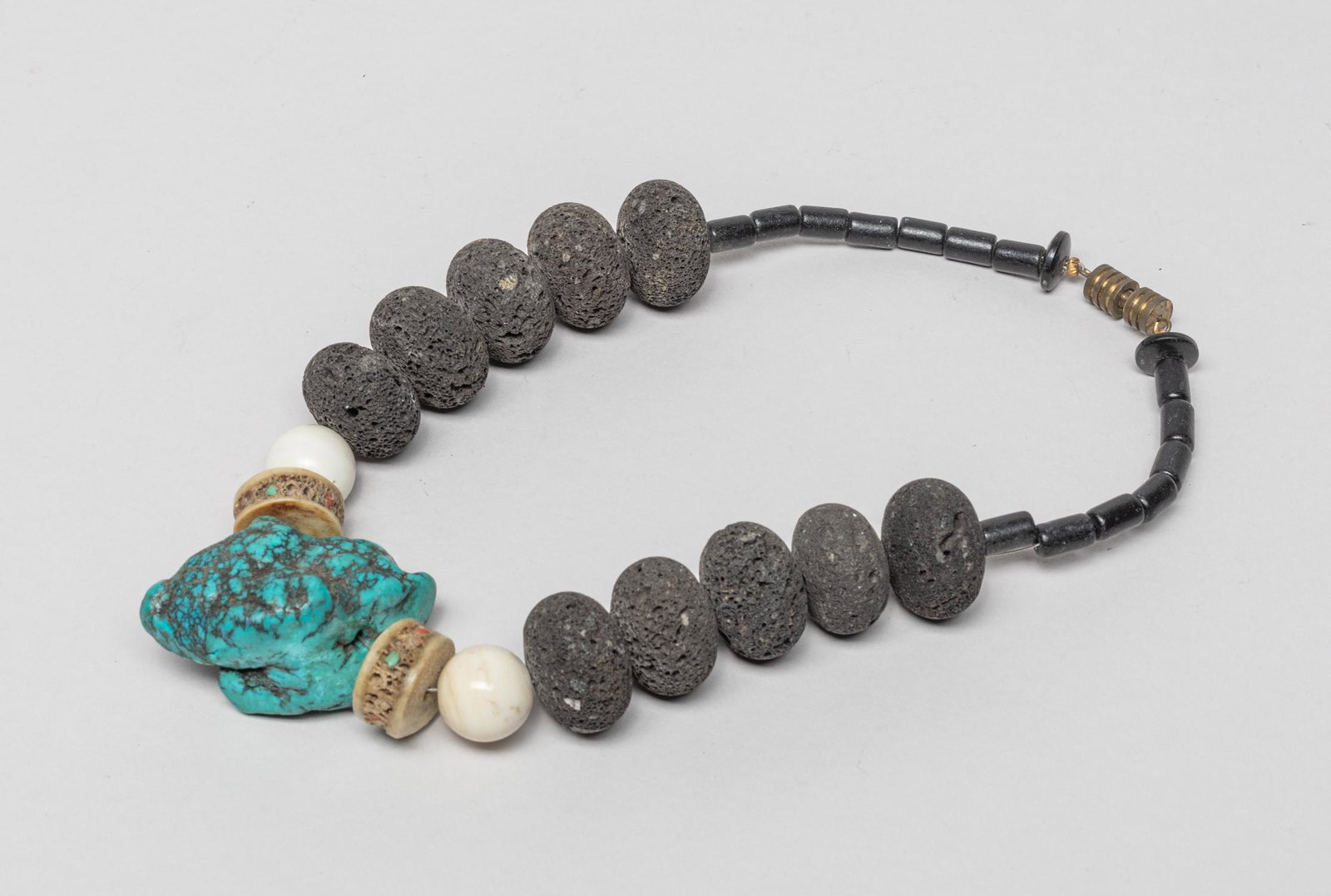 Tibetan Kapala, Turquoise, Volcanic Stone Necklace: Rare large bead necklace comprised of volcanic stone, mother of pearl, Tibetan Kapala beads and a large turquoise nugget pendant. 16inch L.