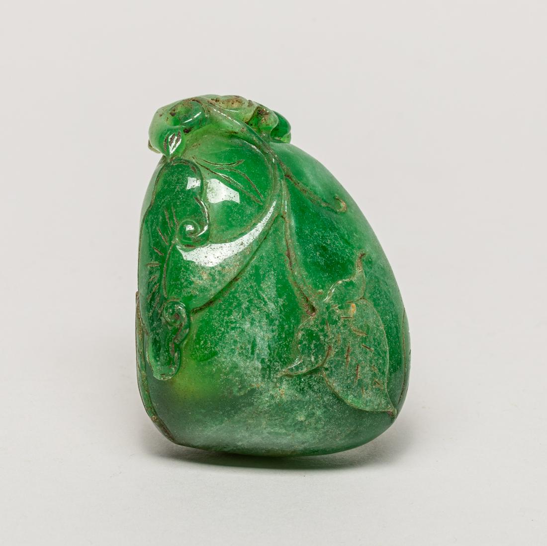Chinese Jade Like Carving of Fruit: The green pebble-shaped carving carved in raised relief with lingzhi and leaf borne on a curled stem. 2.93inch L, 2.25inch W, 1.5inch H.