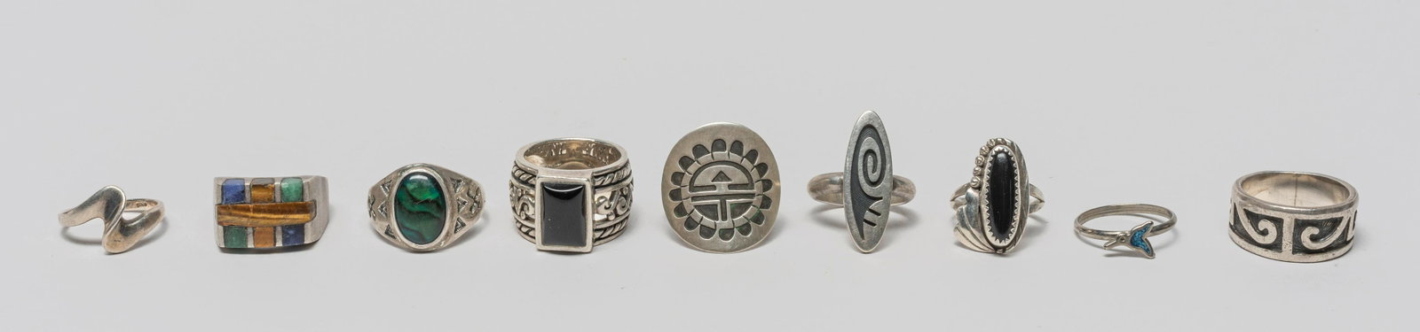Native American & Mexico Silver Rings: Group of nine Native American and Mexican style silver rings, wherein four pieces designed with abstract pattern, the other pieces decorated with gemstone in various colors. US size: 11 (largest).