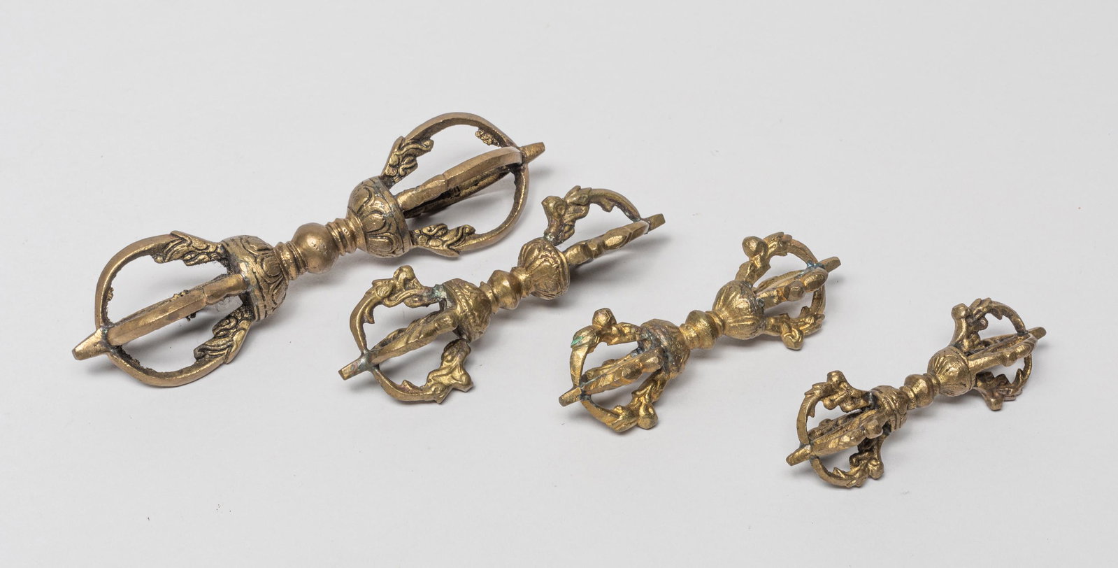 Chinese/Tibetan Old Bronze Vajra: Group of four collectible Chinese/Tibetan bronze Buddhist vajra of typical form. 6.2inch L, 1.3inch W (largest).