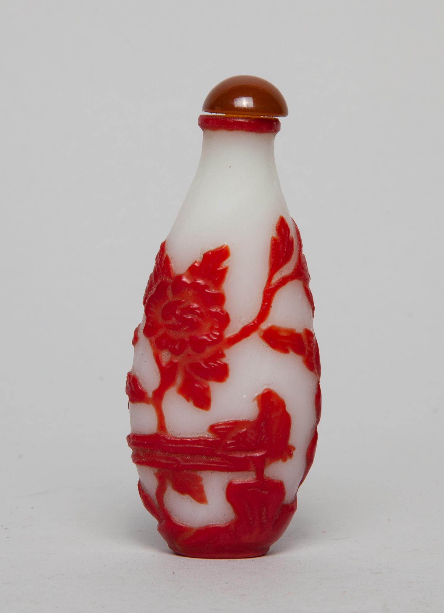 Chinese Overlay Glass Snuff Bottle: Of elongated form, overlaid with design of birds and flowers, in red color on an opaque white ground, with a stopper. 3.5inch H, 1.4inch W.