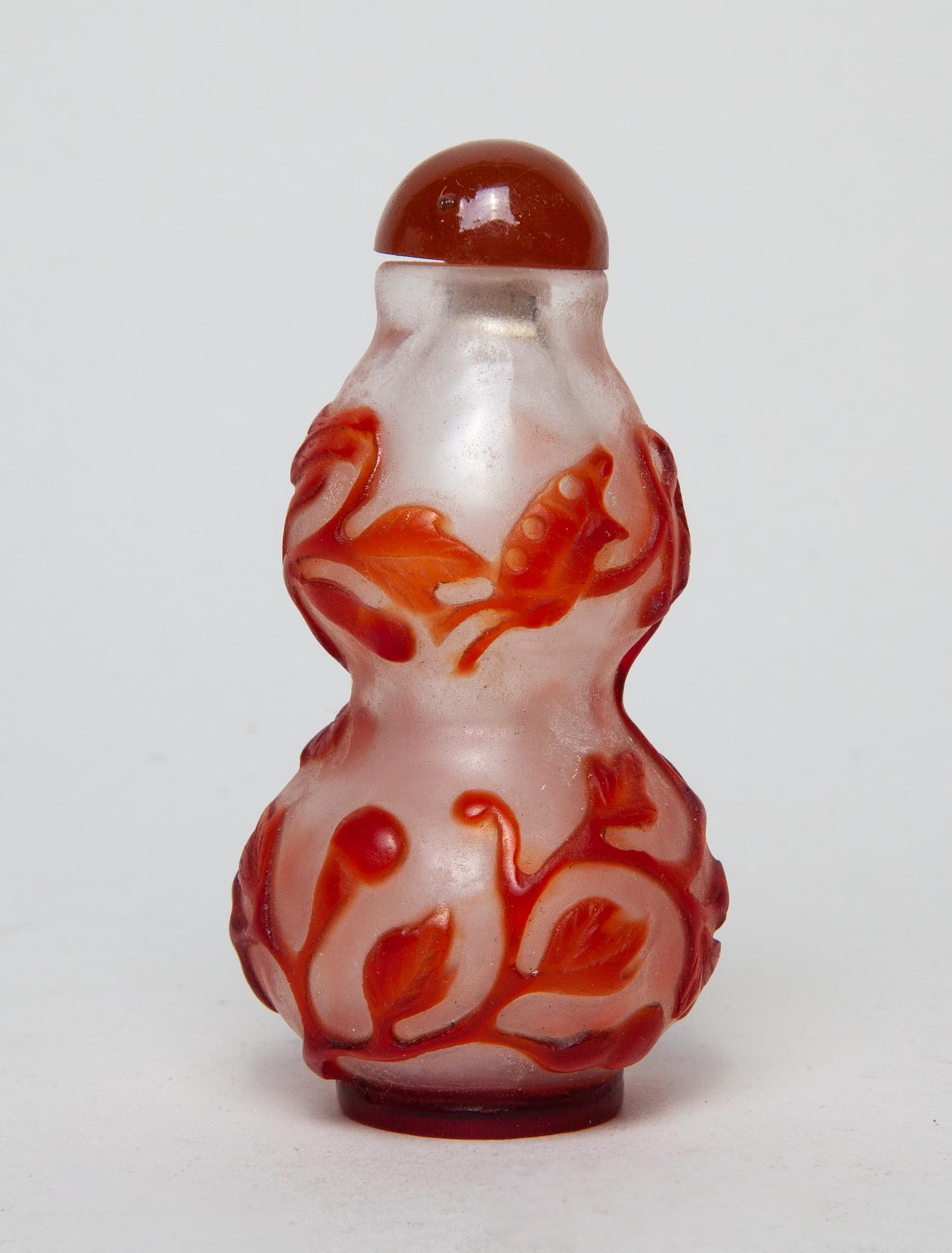 Special Chinese Overlay Glass Snuff Bottle: Of double-gourd form, carved with bird, butterflies and gourds amidst meandering vines and foliage, in brown-red color on a translucent ground, with a matched stopper. 3.2inch H, 1.7inch W.