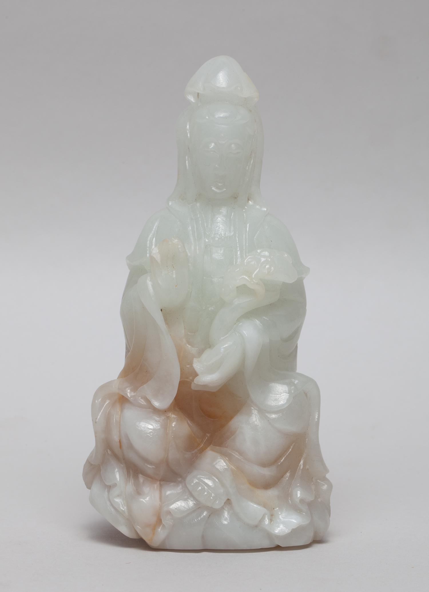 Large Chinese White Jade Carved Kuanyin: Worked in the form of seated Kuanyin, the left hand holding ruyi and right hand in vitarka mudra, wearing long flowing robes open at the chest revealing the bead necklace, the meditative face with ser