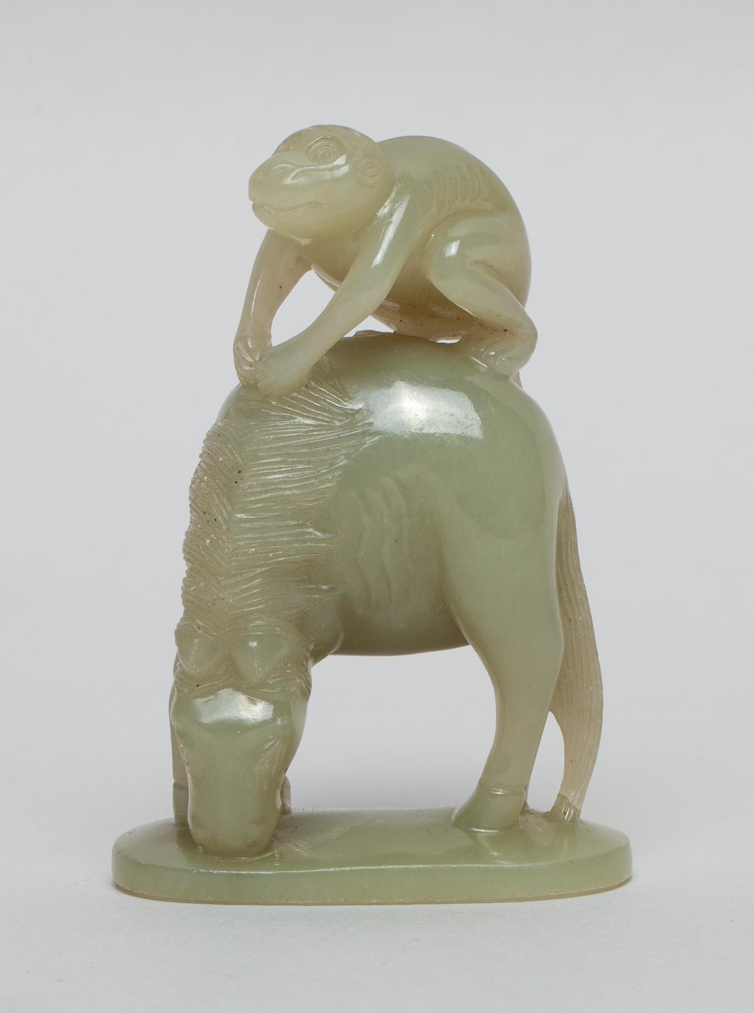 Chinese Pale Celadon Jade Horse & Monkey: Depicting a monkey clambering atop a horse and grasping its mane with both hands, the horse standing on an oval base bowing its head, the stone in an even celadon tone. 3.2inch H, 2.2inch L, 1.1inch W