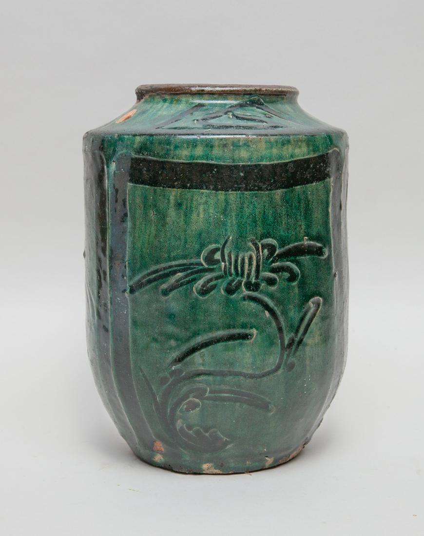 Lg Chinese Malachite Glazed Porcelain Vase: Of cylindrical form rising from a tapered foot to a short neck, the exterior painted and carved with flowers and birds on a dark green ground . 10.2inch H, 7.9inch W.
