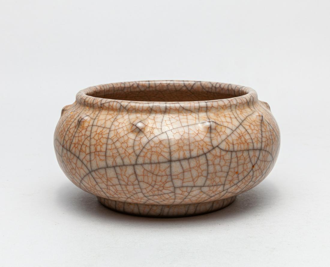 Large Chinese Ge Type Porcelain Brush Washer: The compressed globular body supported on a slightly tapered foot, the shoulder set with ten raised bosses, overall covered with a grayish glaze suffused with a matrix of black and brown crackles. 6.3