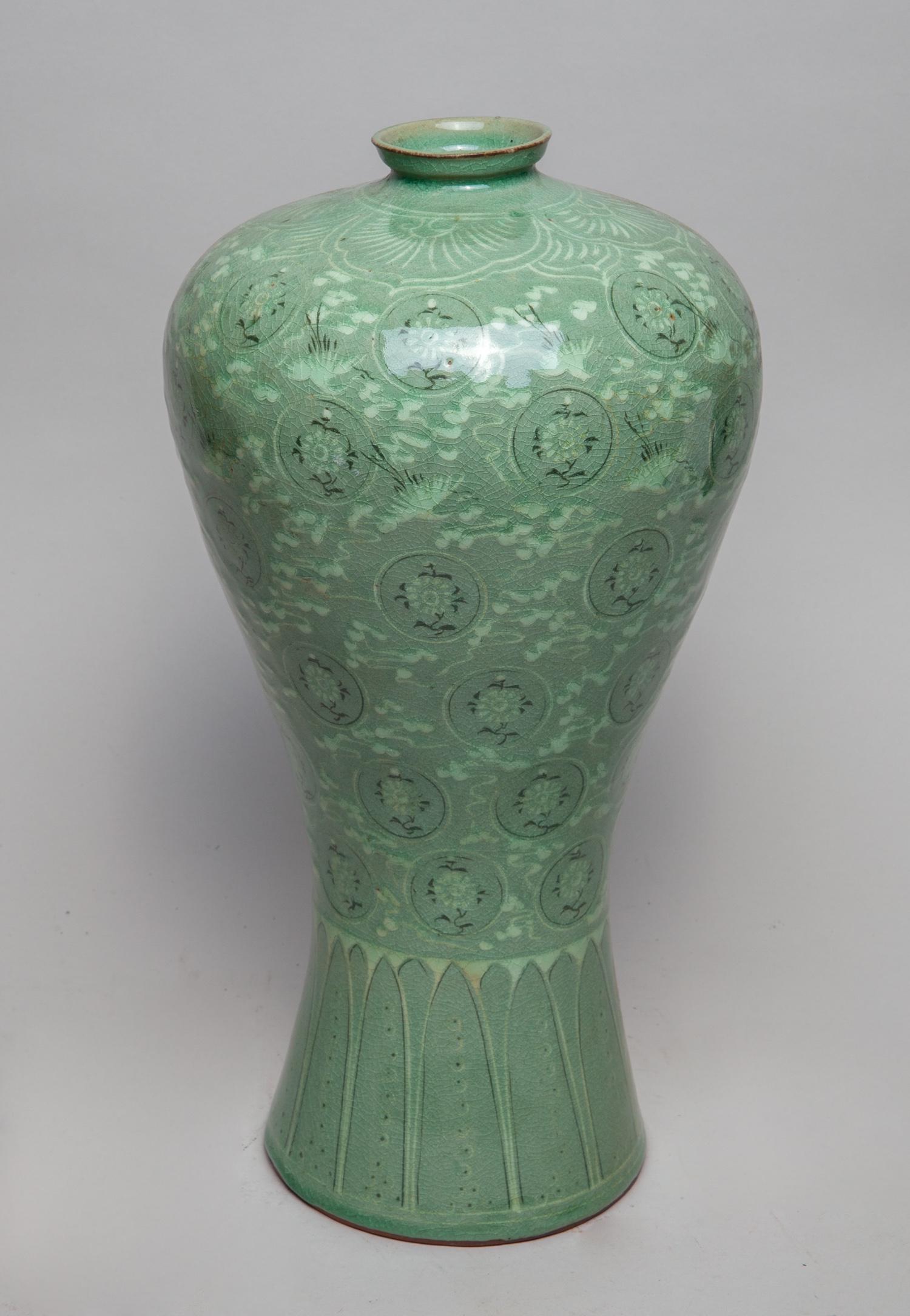 Tall Korean Celadon Porcelain Vase: The ovoid body rising from a spreading foot to a short waisted neck, the exterior painted with cranes and flowers among clouds between bands of overlapping petals, reserved on a celadon ground. Apporx
