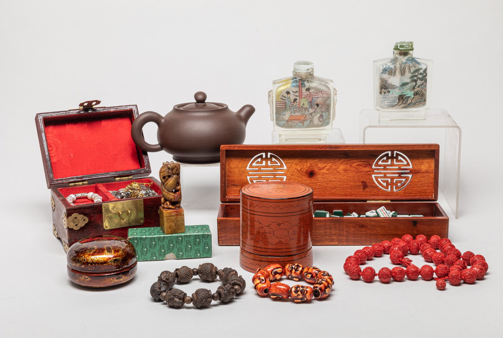 Chinese Jewelry & Snuff Bottles: Including a box of mahjong, beads, a box of costume jewelry, two snuff bottles, and a yixing zisha tea pot. 11inch L, 3inch W (largest box).