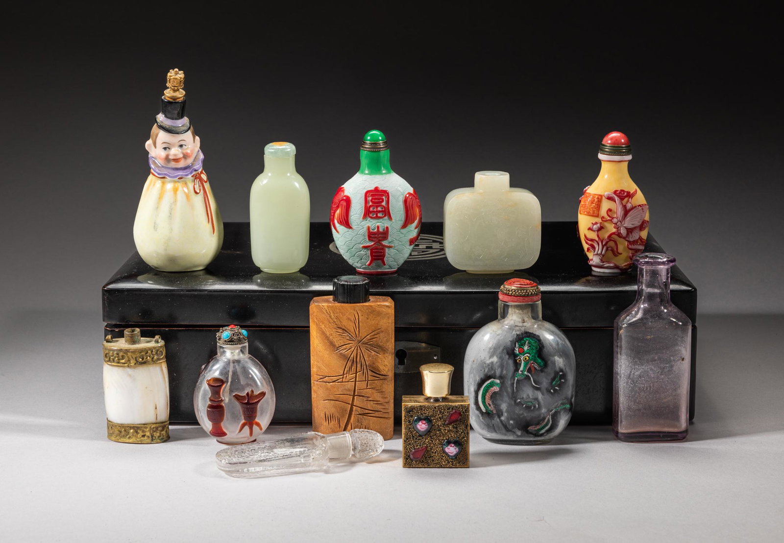 Collectible Chinese Snuff Bottle Sets: Including 8 snuff bottles and 4 perfume bottles, the snuff bottles including a white jade bottle carved with landscape, a well smoothed jade bottle, a glass bottle painted inside with dragons Mong clo