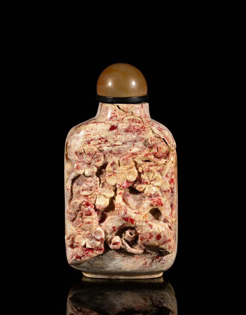 Chinese Chicken Blood Stone Snuff Bottle: Of rectangular form, one side carved in high relief with plum blossoms and the reverse with bamboo, with stopper. 2.75inch H, 1.45inch W.
