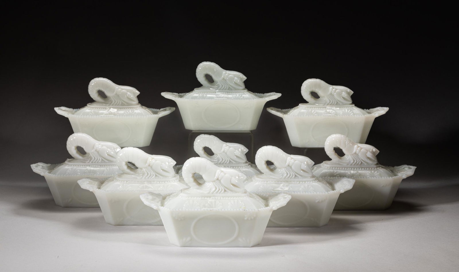 Old Chinese Cream Glass Covered Box: Nine pieces as a group, the even creamy white glass molded in tapering rectangular form with a pair of gently upright handles, the sides set carved with parallel borders and leaves, the cover surmount