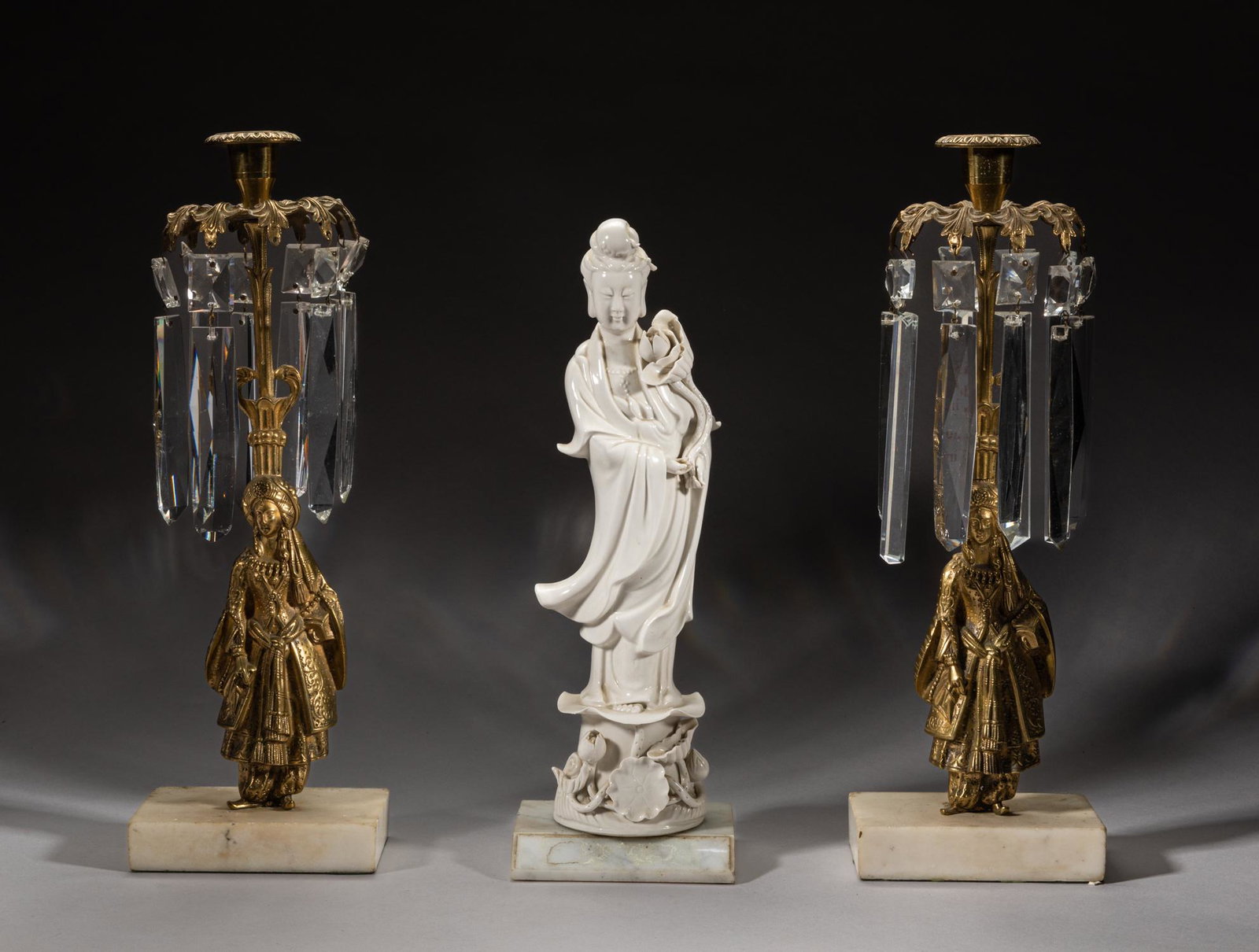 France Louis XVI Type Chinese Blank De Figure Sets: Including a blank de glazed porcelain sculpture, the female standing on a lotus base with hands holding lotus, wearing long flowing robes, and a pair of brass and glass cur candlestick holders, with r