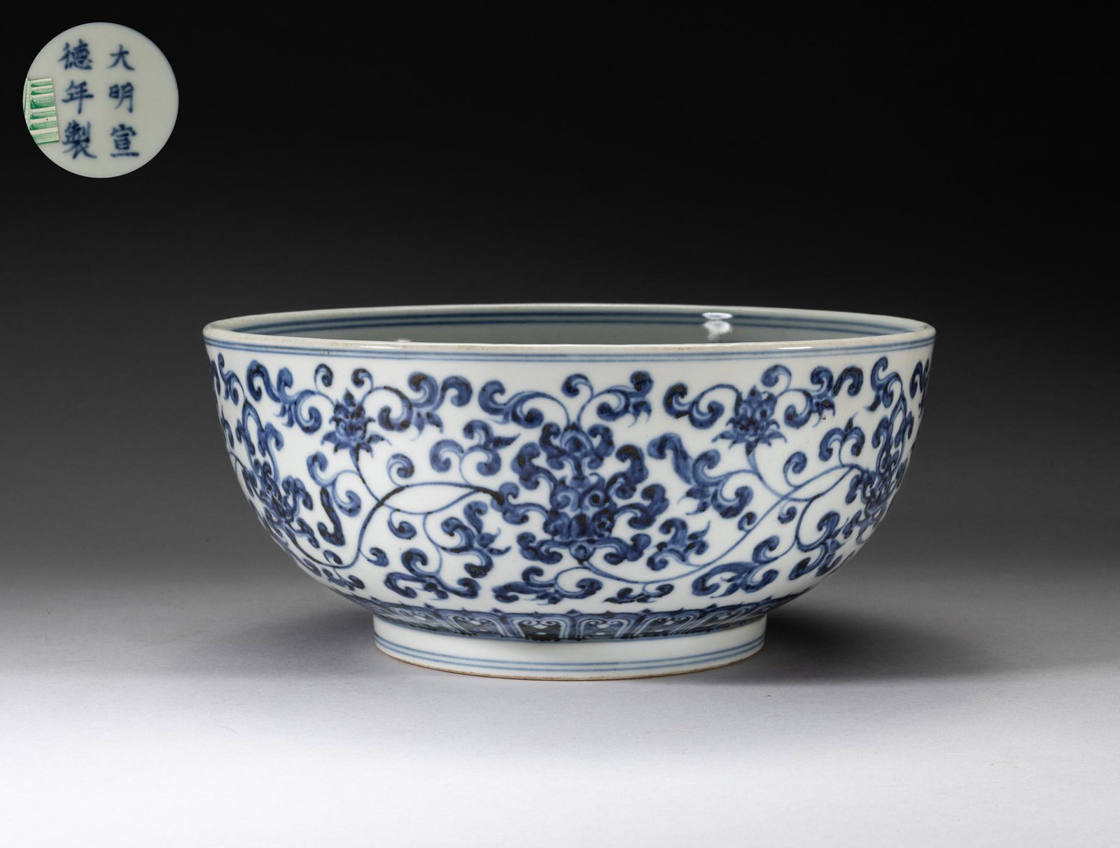 Chinese Blue & White Porcelain Large Lotus Bowl: The interior centre decorated with a circular cartouche of a sinuous dragon amid clouds, surrounded with four beast masks at the sides, the exterior painted with undulating lotus sprays above a band o