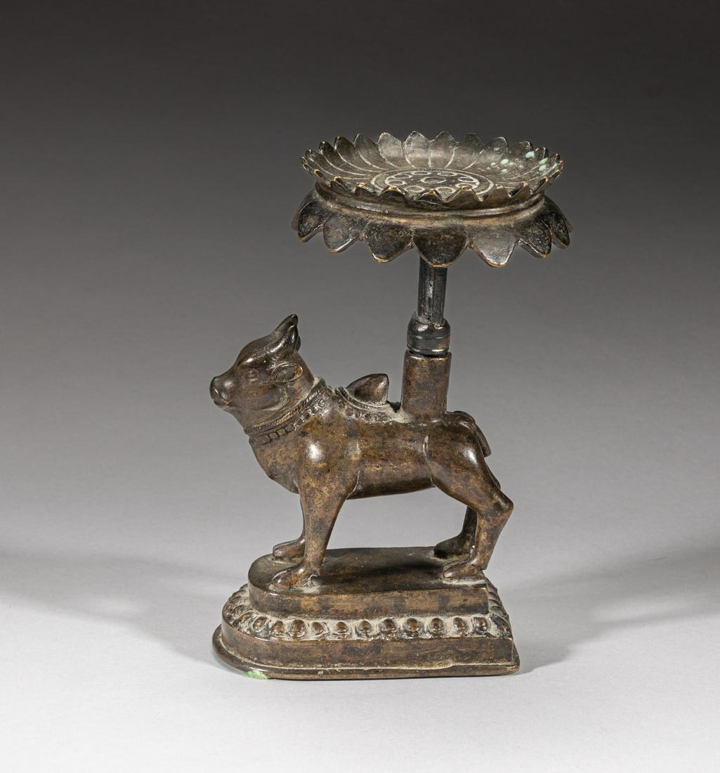Antique Indian Temple Used Bronze Lotus: Molded as a cow standing on an arched rectangular base carved with lotus petals, supporting a tall lotus dish with lobed rim on the back. 6.2inch H, 4.3inch L, 3.4inch W.