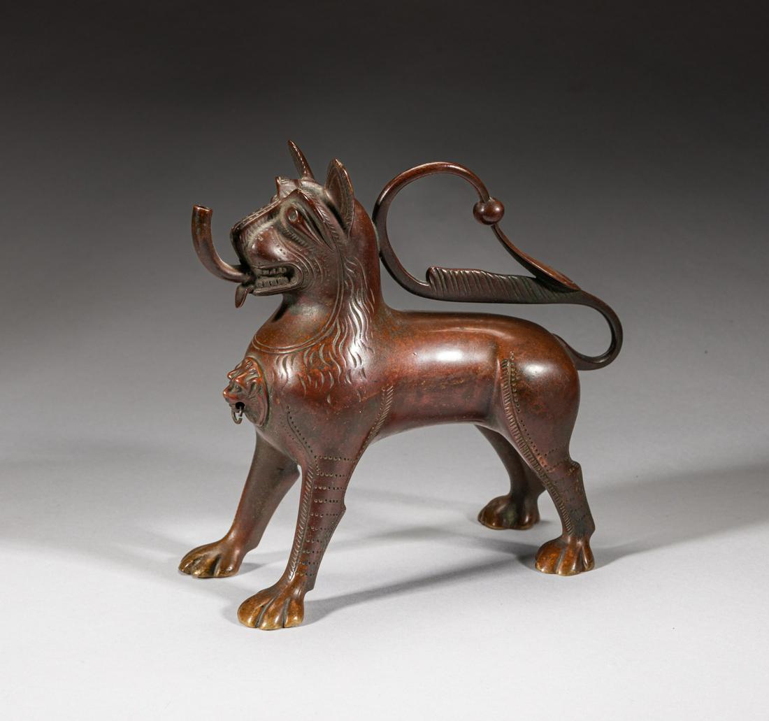 Antique Indian Temple Used Bronze Piece: Cast in the form of standing hollow beast, the chest carved with a beast mask, the long tail curled along its back. 7.2inch L, 2.4inch W, 6.5inch H.