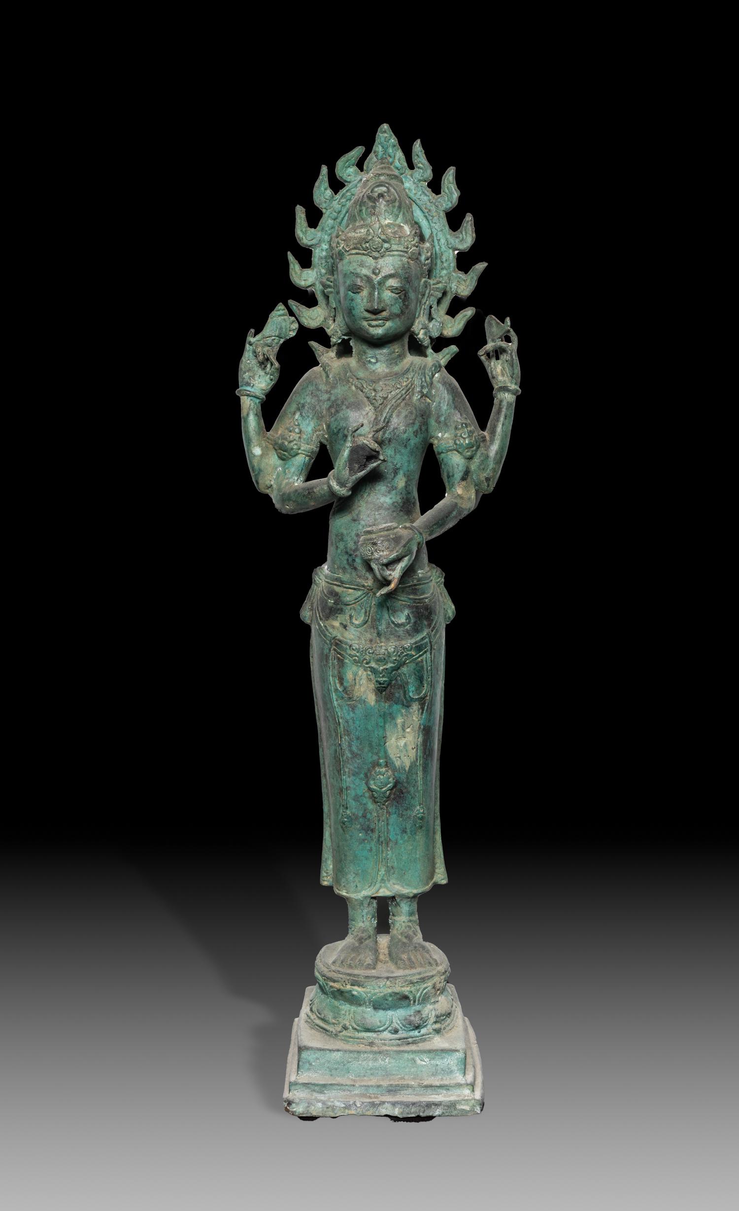 Old South Asian Bronze Tall Buddha: Collectible South Asian Cambodia type bronze Buddha, cast standing on a lotus base, the front pair of hands in vitarka mudra and holding an elm bowl, the other pair of hands holding implements, with a