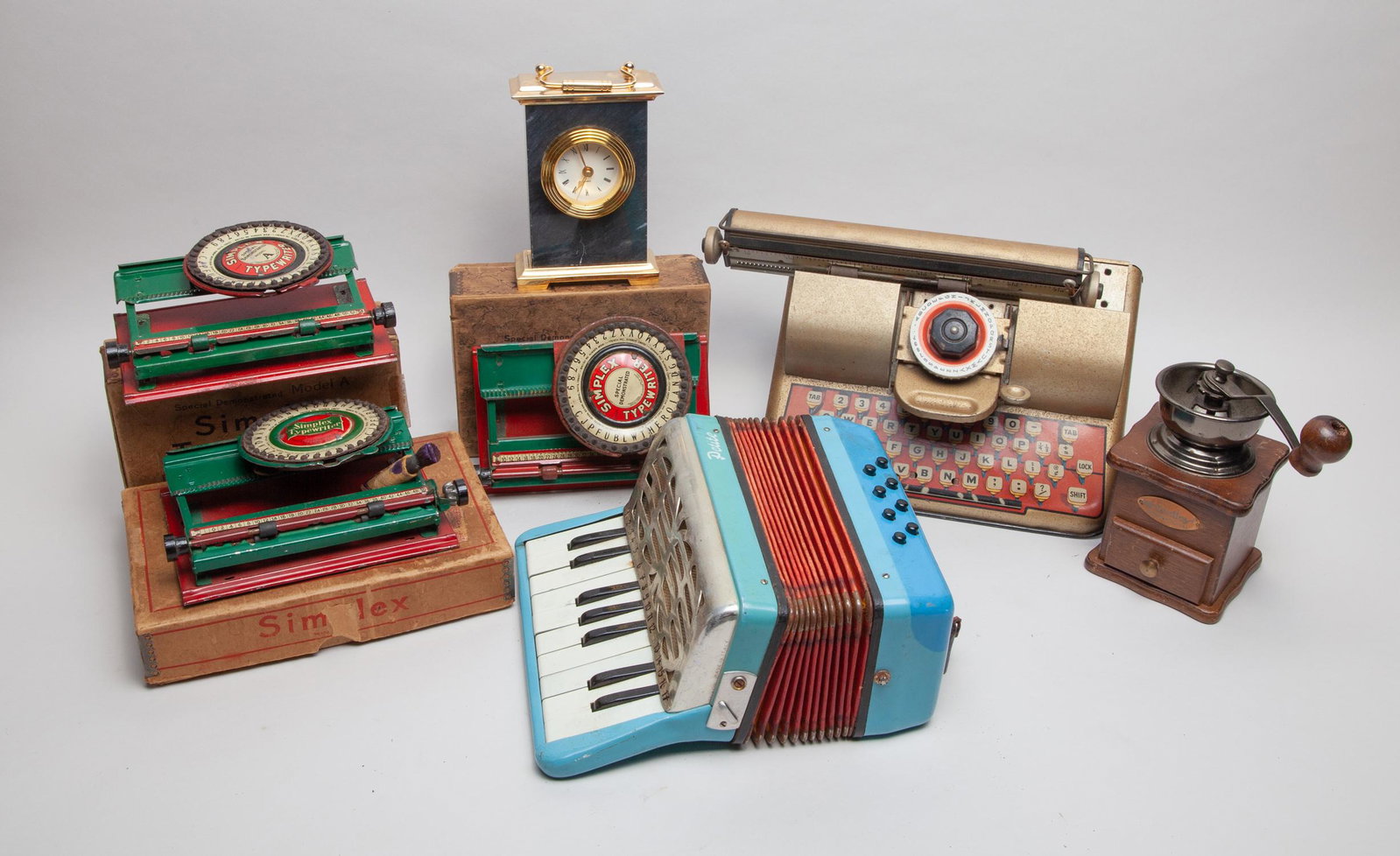 Collectible Simplex Typewriter & Machine: Including an instrument, a table clock, a coffee grinder, and four Simplex typewriter models. 10.2inch L, 7inch W, 4inch H (largest).