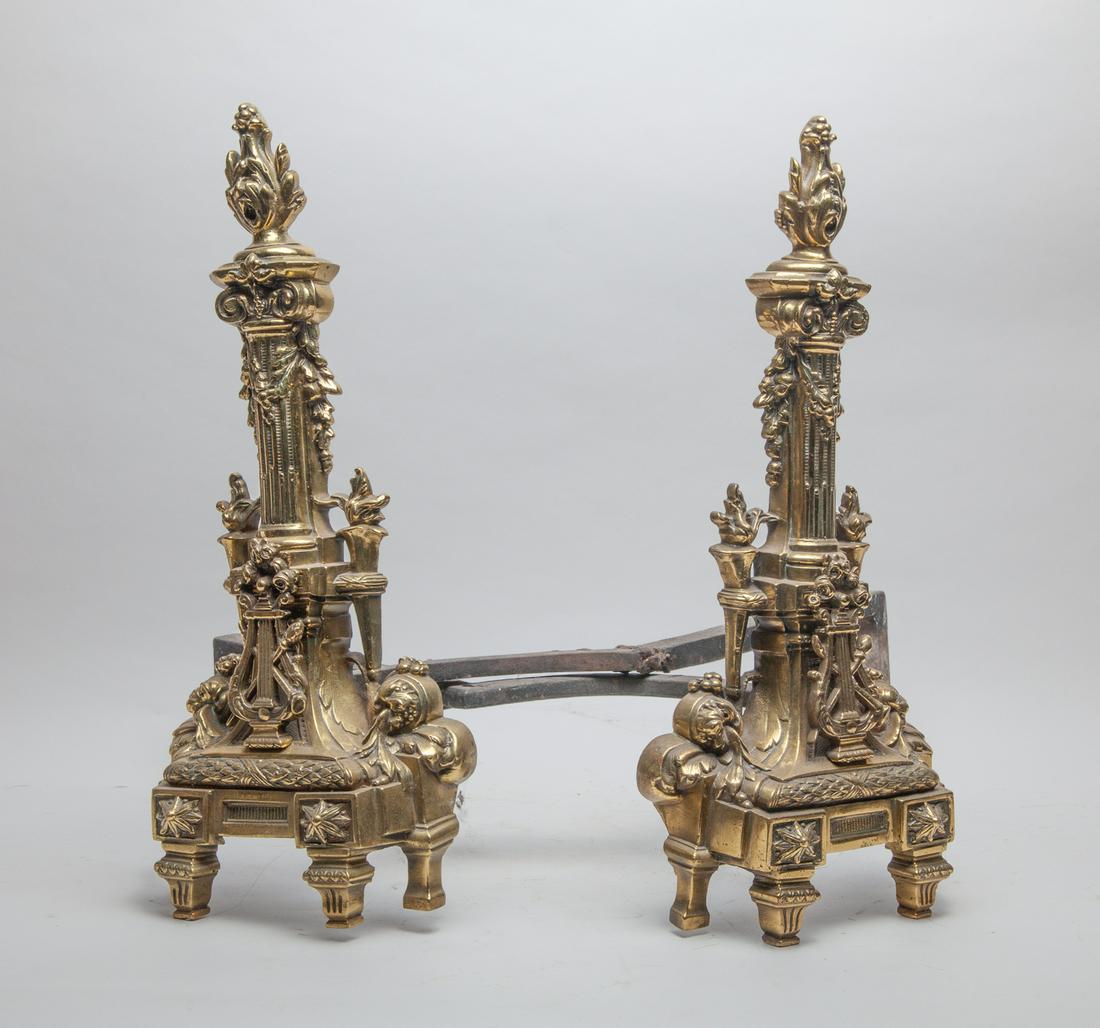 Pair France Louis XVI Type Fireplace Andirons: A pair of collectible French type iron fireplace andirons, cast in elaborate style and painted in golden coloring. 22inch W, 18inch H (each).