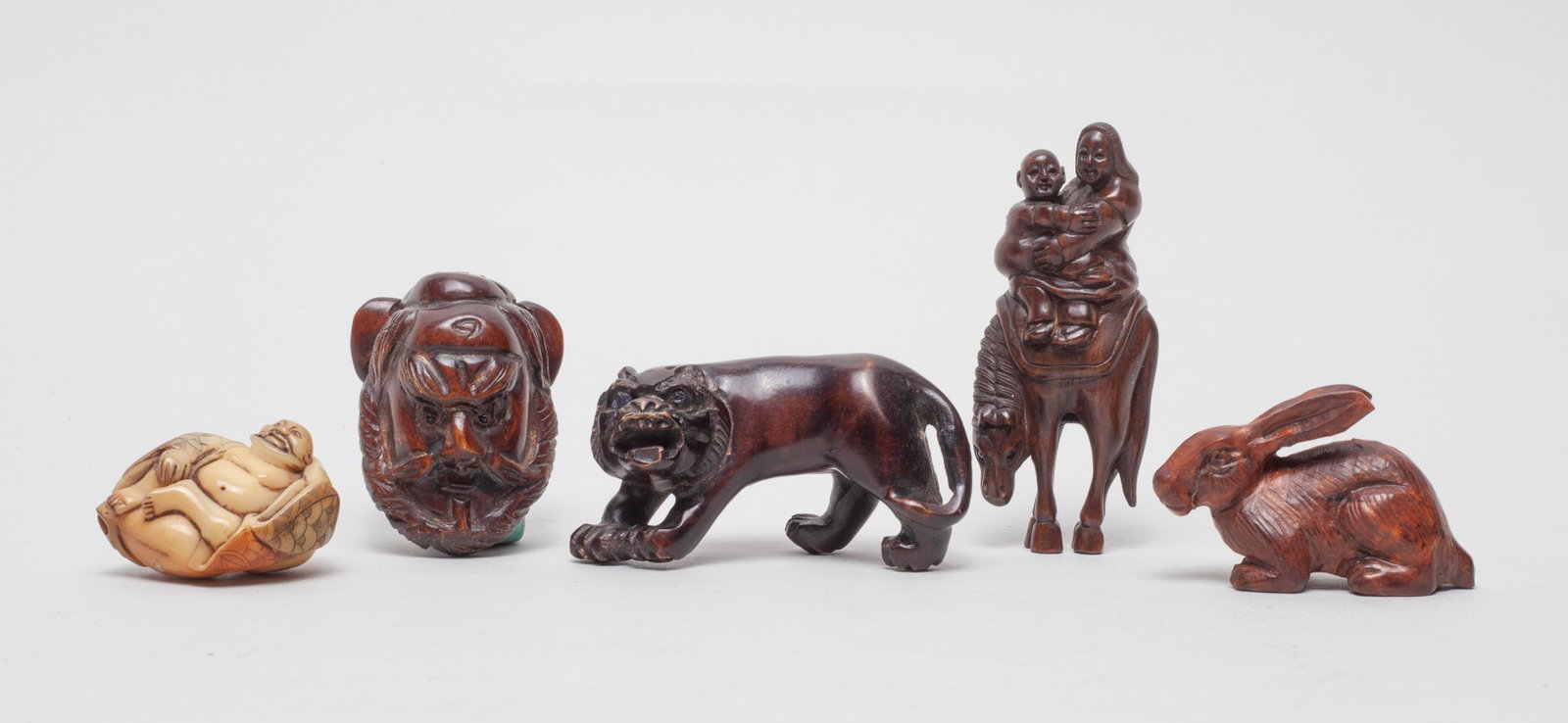 Japanese Wood & Nuts Netsuke: Five Japanese wood and nut carved netsuke, carved in the form of buddha, beast, rabbit, man head, or a woman and a body sitting on a horse, wherein two pieces with mark. 2.95inch L, 1.25inch L, 0.85in
