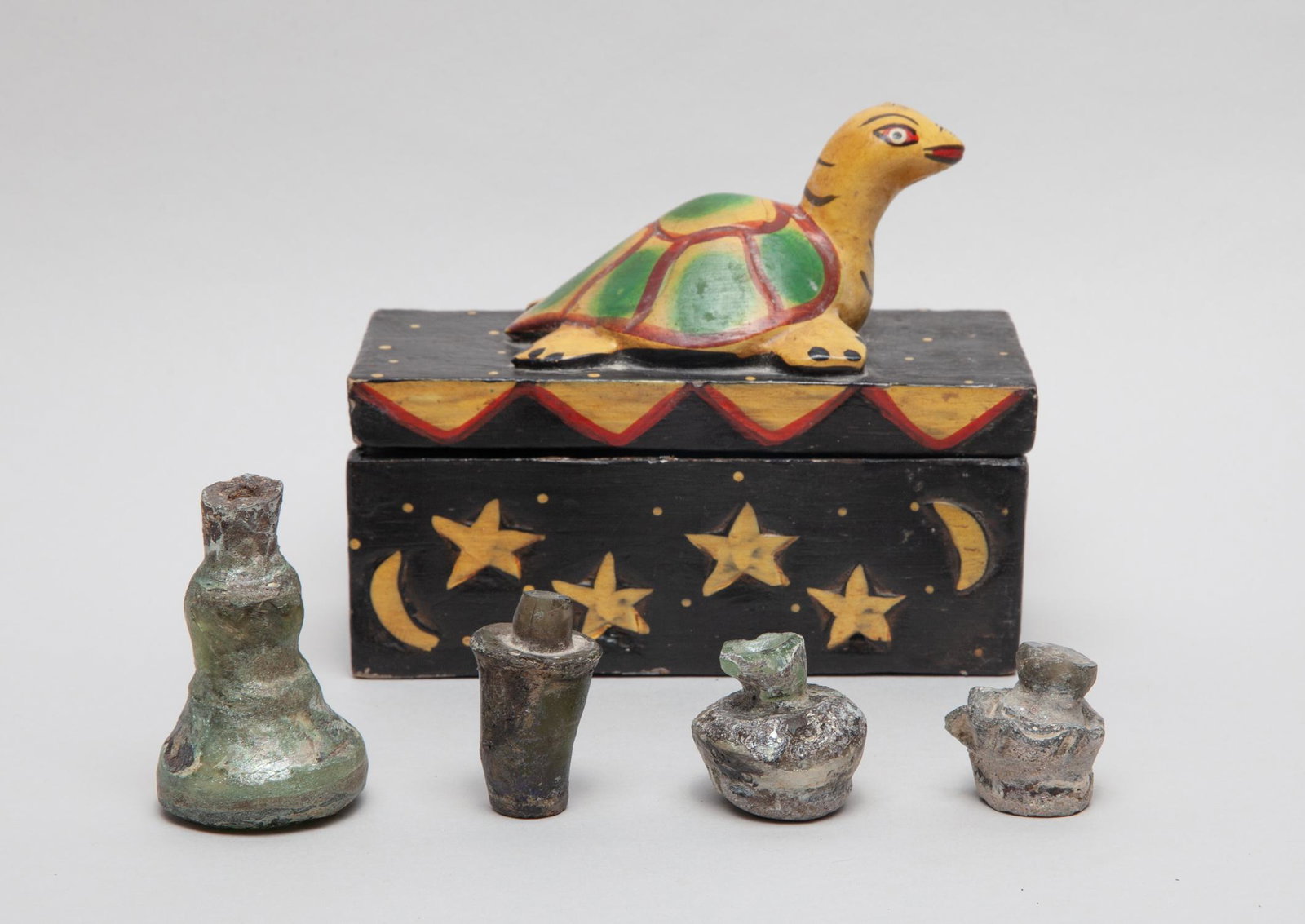Antique Roman Glass Bottles: Group of four collectible Roman glass bottles, with a box set with a large turtle finial. 2.65inch H, 1.7inch W (largest bottle).
