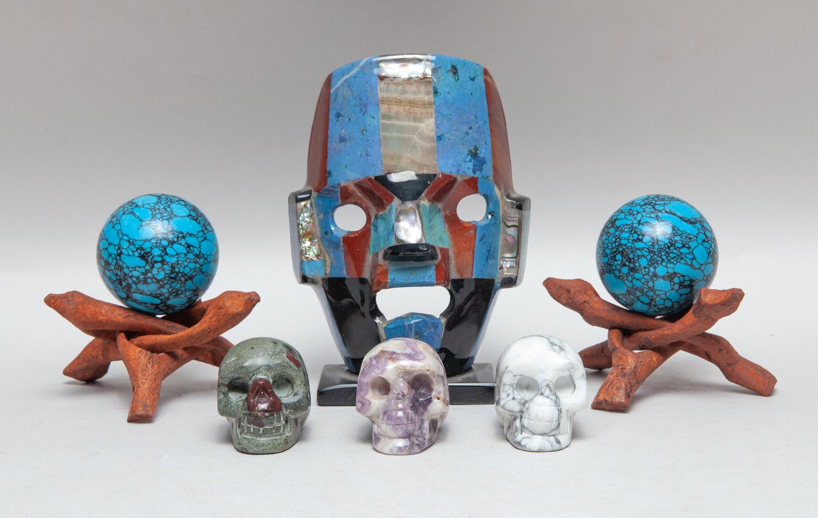 Estate Gemstone Table Sculptures: Including three gemstone carved skulls, two turquoise like balls with stands, and a special gemstone mask type table decor. 5.5inch H, 3.9inch L, 2.2inch W (largest).