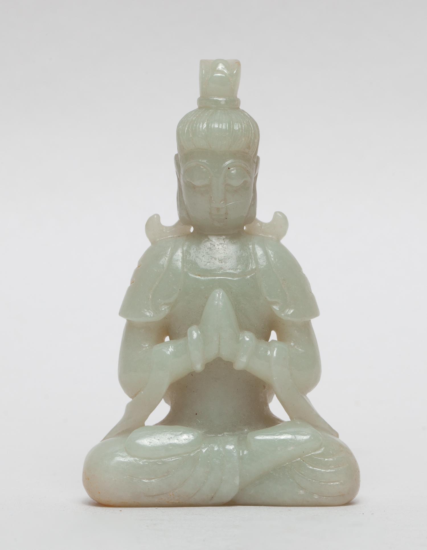 Rare Chinese Jade Seating Buddha: Finely carved seated in dhyanasana with hands held in Anjali mudra, the face directed forward with a serene expression and lowered eyelids, the stone in pale celadon color with russet inclusions. 3.25