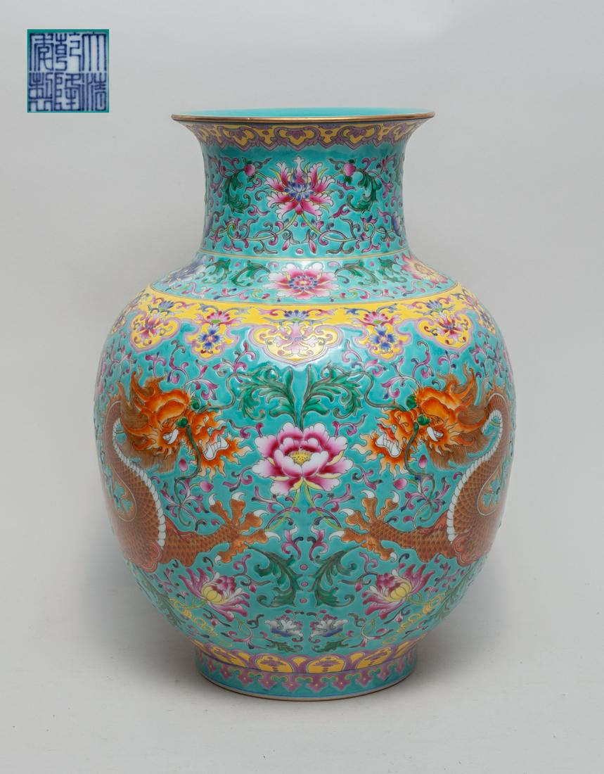 Chinese Export Famille Rose Porcelain Vase: The exterior enameled with a pair of dragons among undulating lotus scrolls between ruyi head and petal bands, against a turquoise ground, the base with a six-character mark. 13.3inch H, 10inch W.