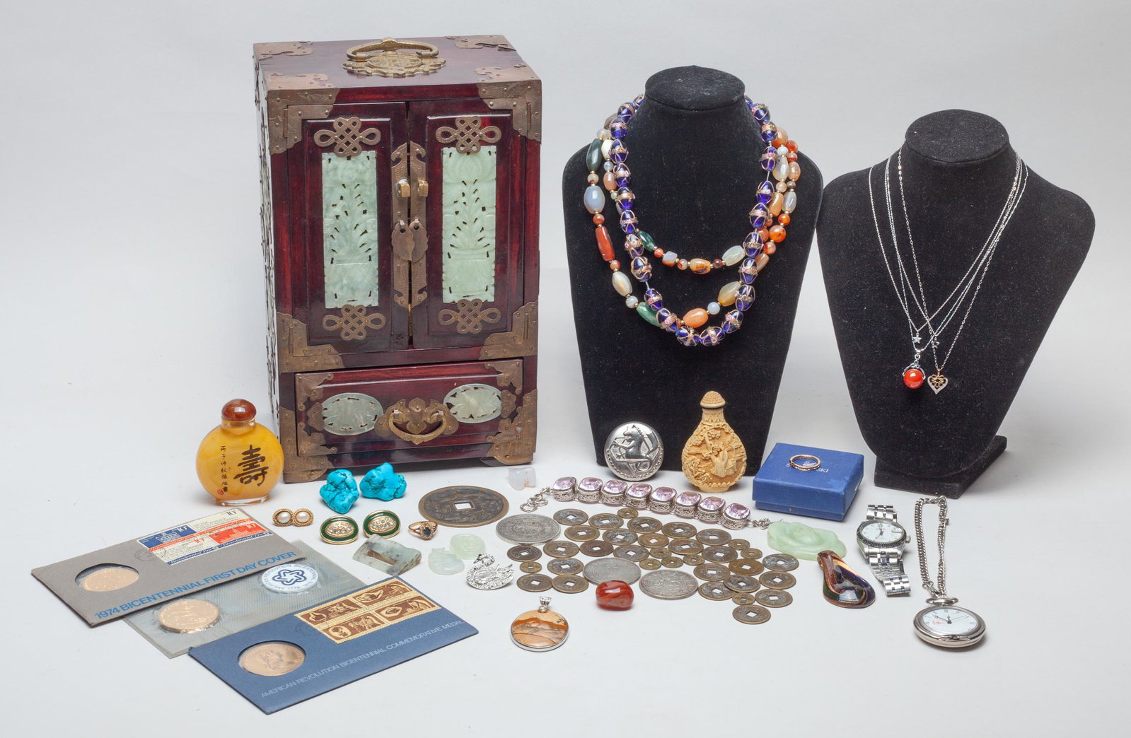 Estate Chinese Coin, Snuff Bottle, World Jewelry: Including wrist watches, necklaces, rings, earrings, brooches, pendants, carvings, Chinese and American coins, a bone like carved snuff bottle, a glass snuff bottle, and a pocket watch, with a wood je