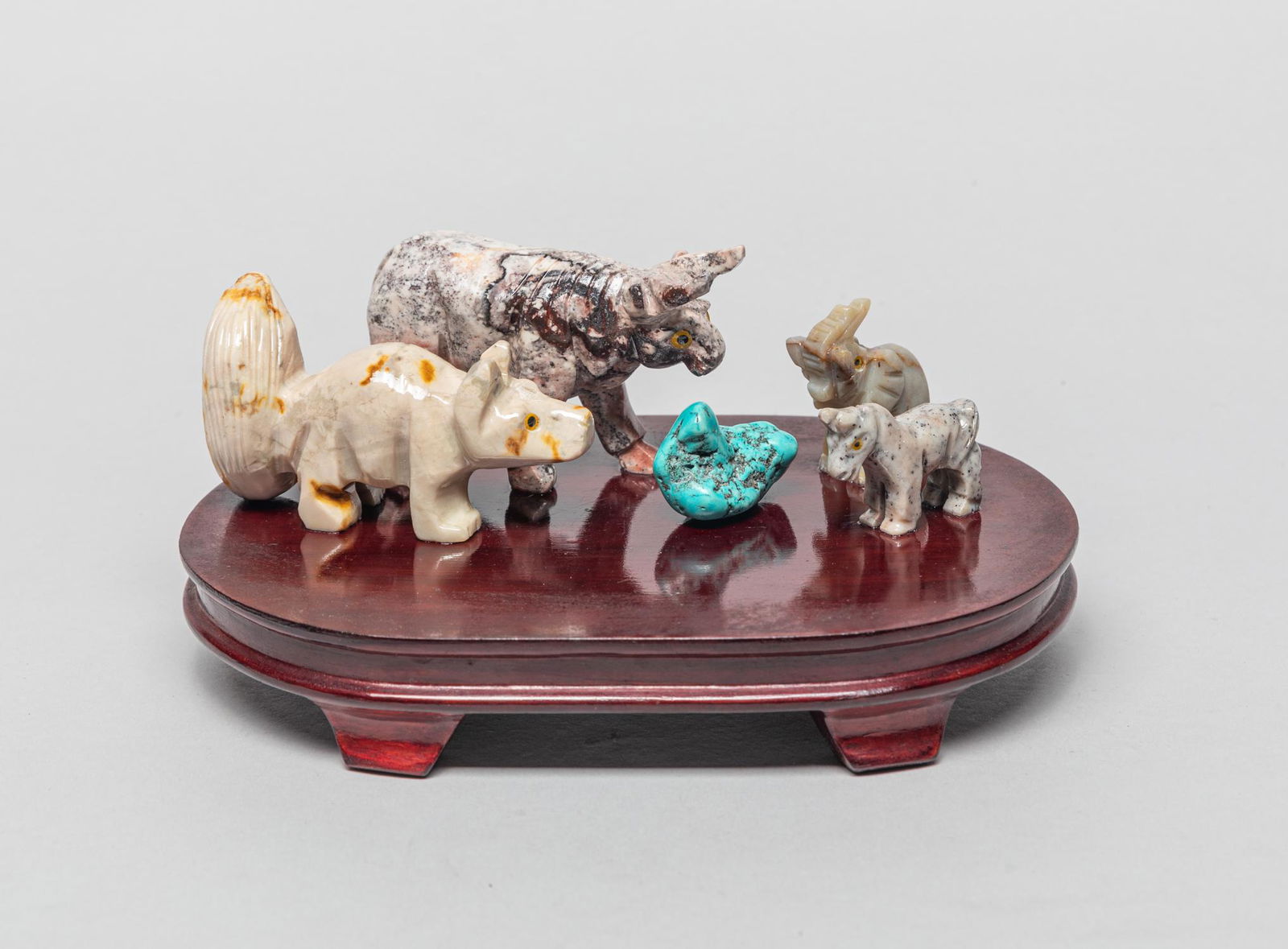 Zuni Type Large Gemstone Animal Sets: Gemstone animals carved in style Zuni, in form of rhino, elephant, horse and dog, with a turquoise like nugget, all supported on an oval-shaped stand. 7inch L, 4.8inch W. 3inch H (w/ stand)