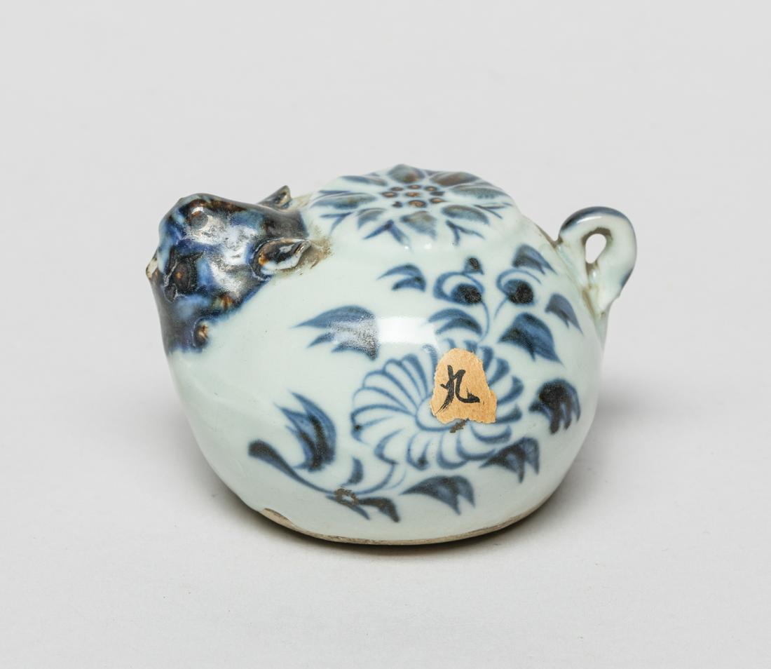 Chinese Blue & White Porcelain Water Pot: Of compressed form, painted with blooming flowers, set with a beast mask spout. 2.8inch L, 2.5inch W, 1.8inch H.
