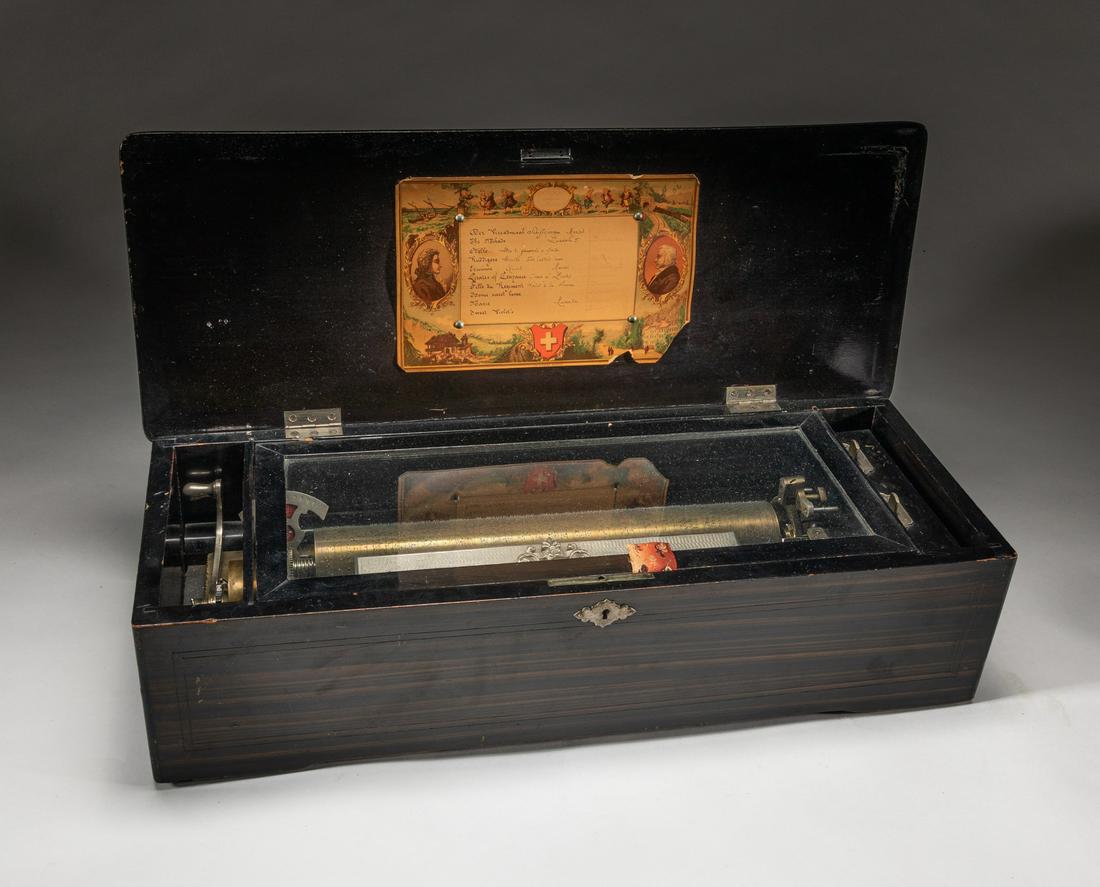 Collectible Swiss Interchangeable Cylinder Music: Collectible Swiss interchangeable cylinder music box, with a note and a wood box carved with flowers. Musical box is automatic musical instrument in a box that produces musical notes by using a set of