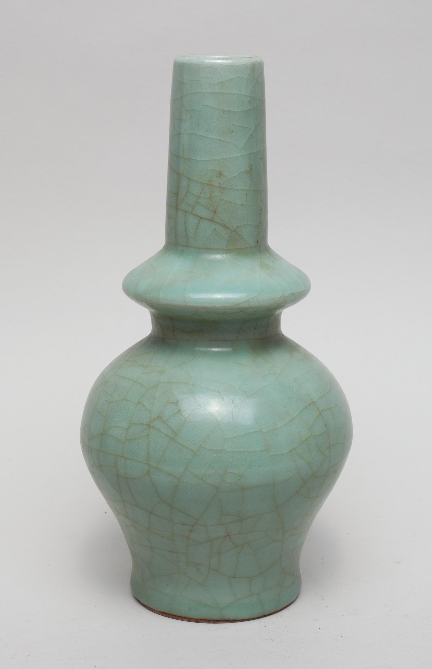 Special Form Chinese Longquan Porcelain Vase: The ovoid body rising from a gently splayed foot to a compressed bulb and a columnar neck, covered overall in a crackled celadon glaze. 9.3inch H, 4.6inch W.