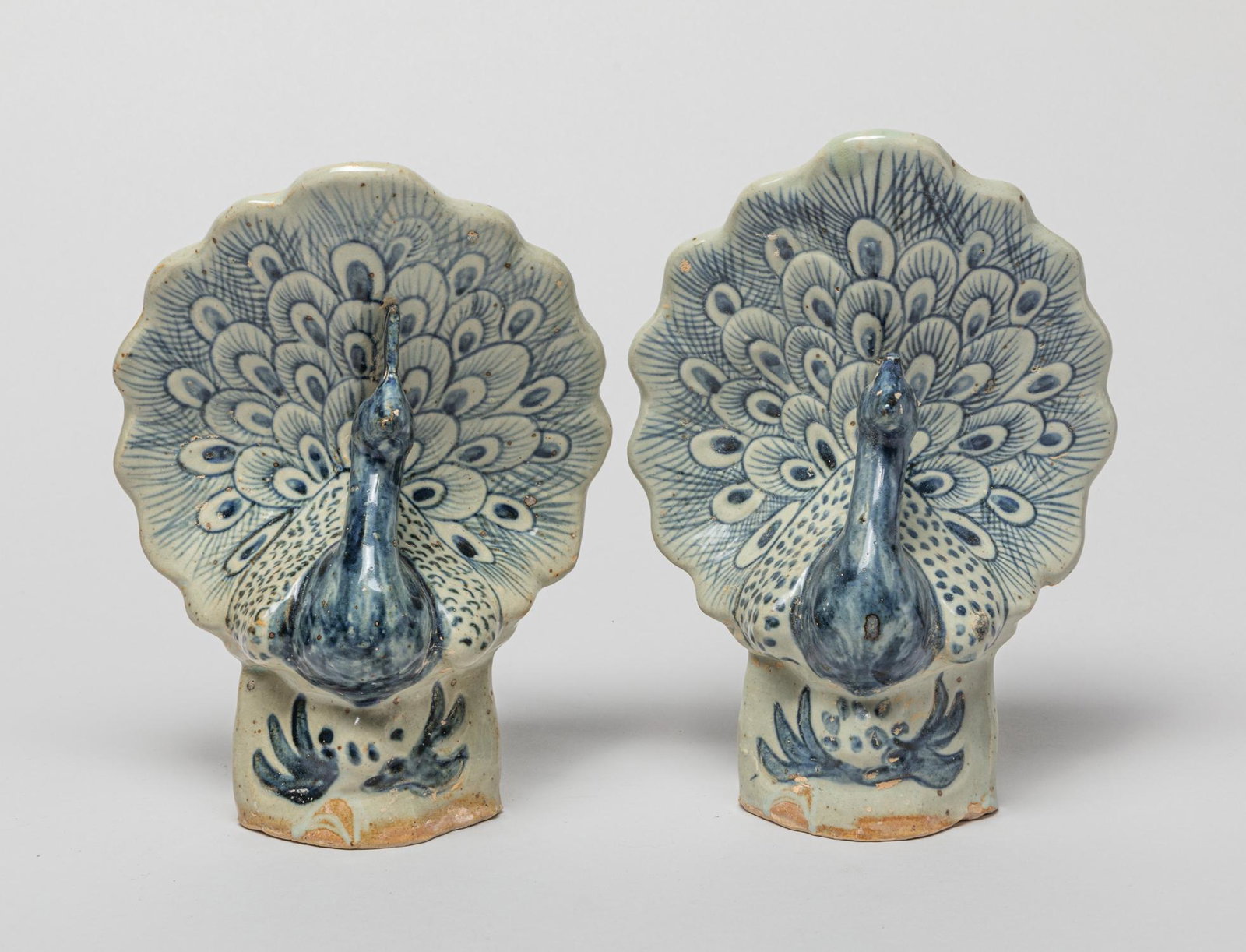 Pair Hoi An Shipwreck Porcelain Sculpture: A pair of special Hoi An style blue and white hollow porcelain sculptures molded in peacock form, with spreading tails and protruding peaks. 8.2inch H, 6inch L, 4.2inch W (larger).