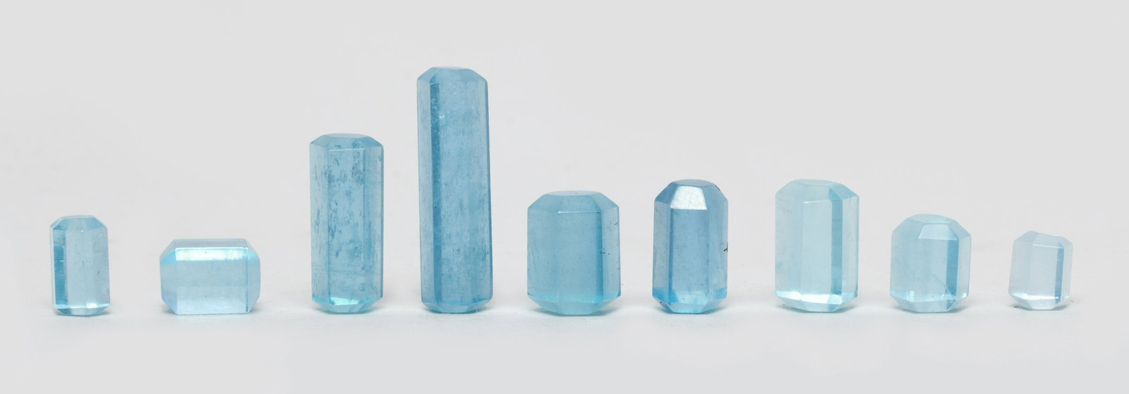 High Quality Aquamarine Nuggets: Group of nine pieces of high quality aquamarine, aquamarine is a blue or cyan variety of the beryl family, as one of the most popular blue gemstones, aquamarine is steeped in myth and legend. Approx. 
