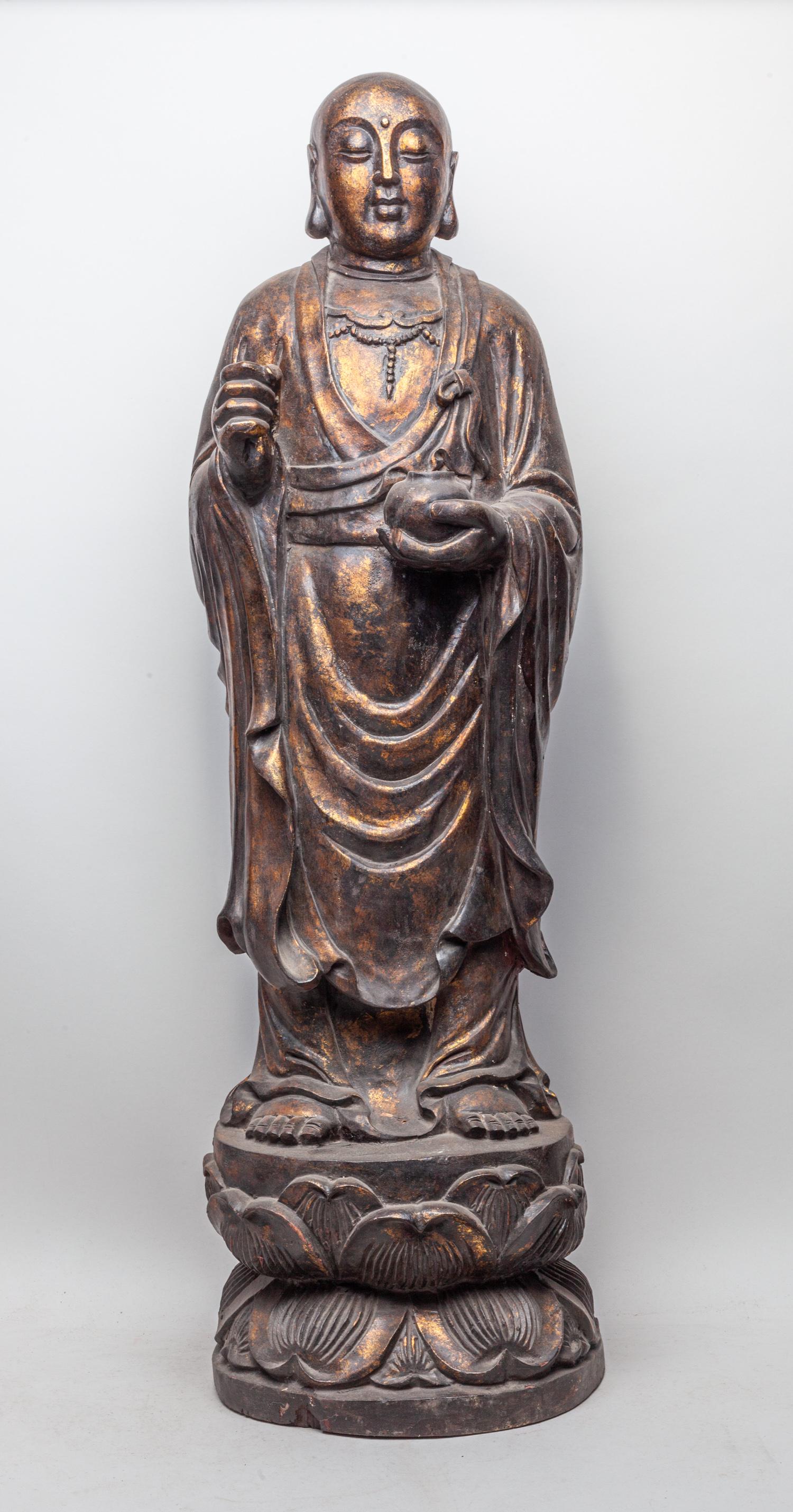Tall Chinese Wood Carving of Buddha: Carved standing on a double lotus throne, his left hand holding a bowl and right hand holding missed stuff, wearing a long robe opening at the chest to reveal beaded jewelry, the meditative face with 