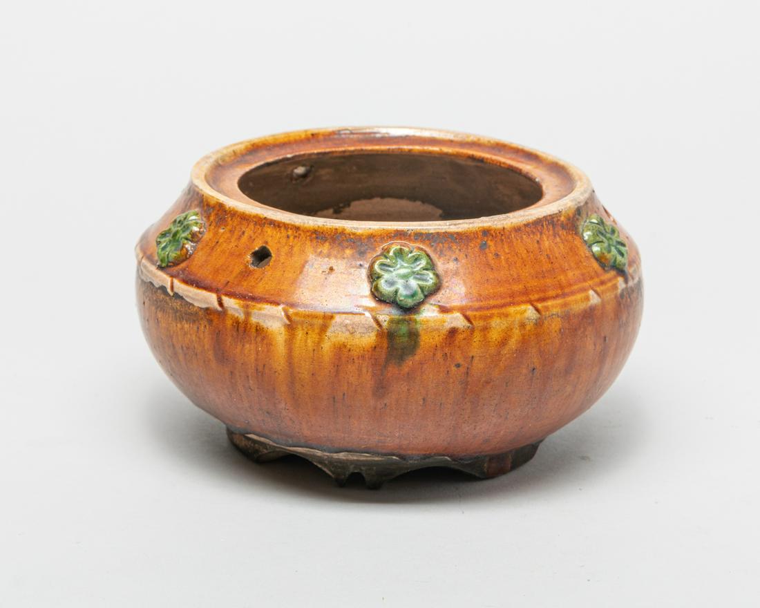 Chinese Glazed Pottery Washer: Of compressed globular form, the exterior covered in honey-brown glaze and carved with flowers at the mouth glazed in green color, the unglazed bottom revealing the stoneware body. 6.5inch W, 3.5inch 