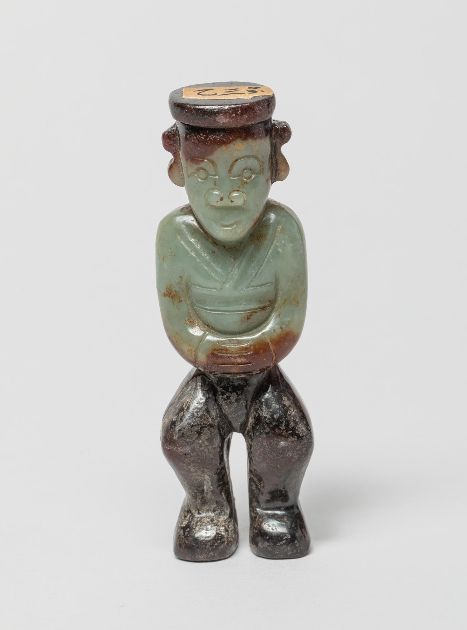 Chinese Russet Jade Figure: Collectible celadon and russet jade carved in figure form. 3.1inch H, 1inch W. The Estate of the Arioka, Little Tokyo LA, Store Closed Sale, 2020.