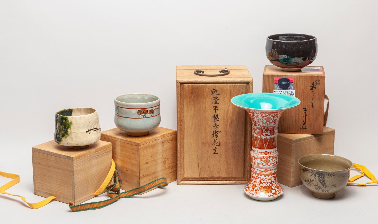 Estate Chinese/ Japanese Porcelain Sets: Including 4 Japanese glazed porcelain bowls and a vase painted with iron-red lotus sprays, the bottom marked six characters, each with a box. 8.8inch H, 6inch W (vase size).