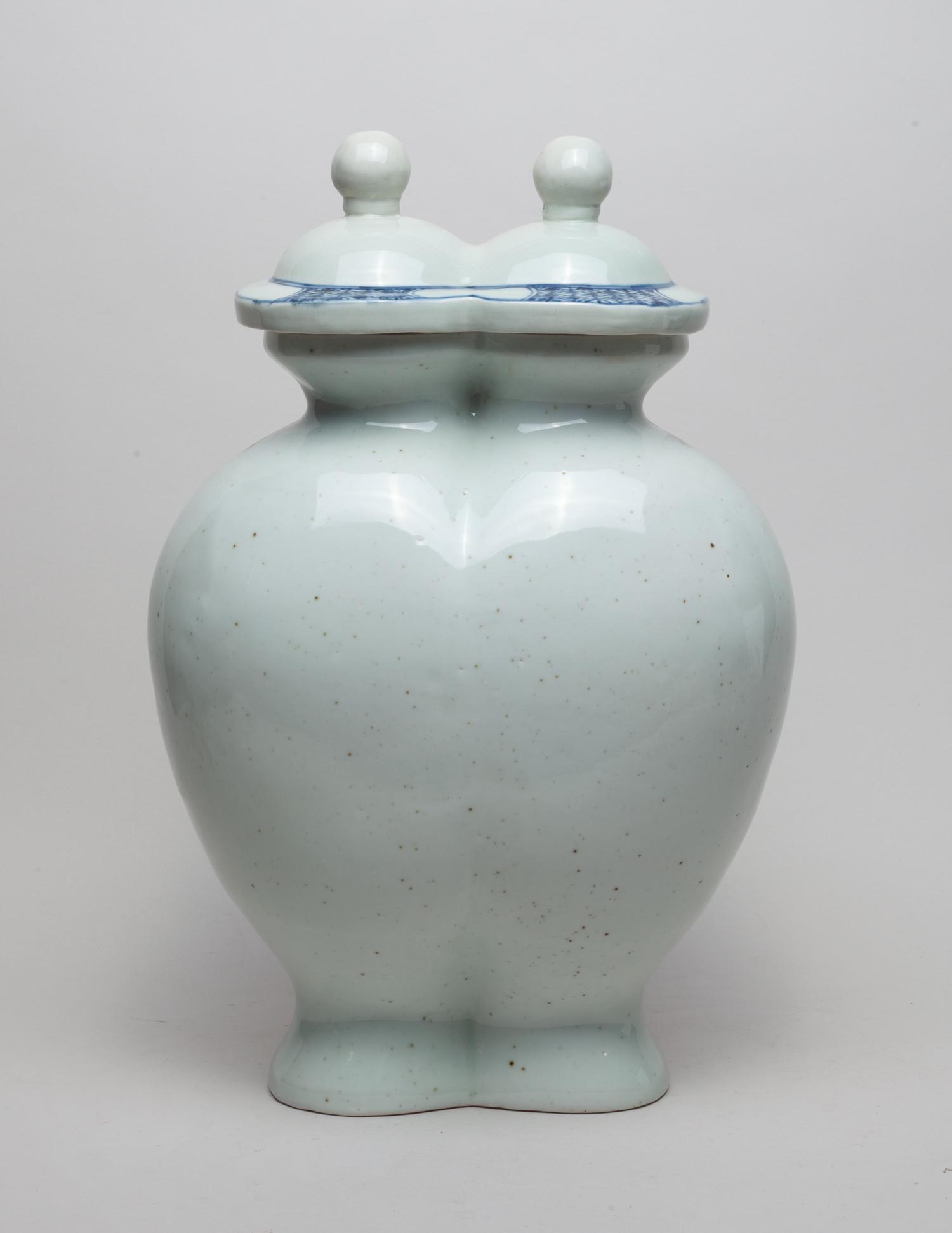 Special Korean Porcelain Vase: Special form white glazed porcelain vase with a blue and white lid. 16.5inch H, 10.7inch L, 7inch W.